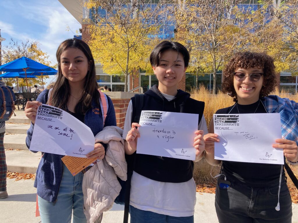 Students hold "I Stand with Immigrants Because..." signs at the Butterfly Coalition and CPS's Day of Action event on Nov. 2, 2022 (Photo Alli Dayton/The Gettysburgian)