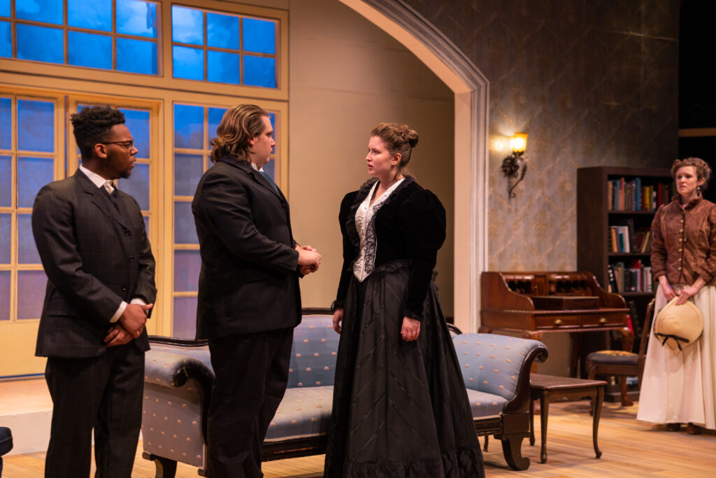 From left to right: Mike Peck '23 plays Jorgen Tessman, Eric Lippe '24 plays Judge Brack, and Roisin Daly '23 plays Hedda Tessman (nee Gabler) in "Hedda Gabler" (Photo courtesy of Alex Sanchez)