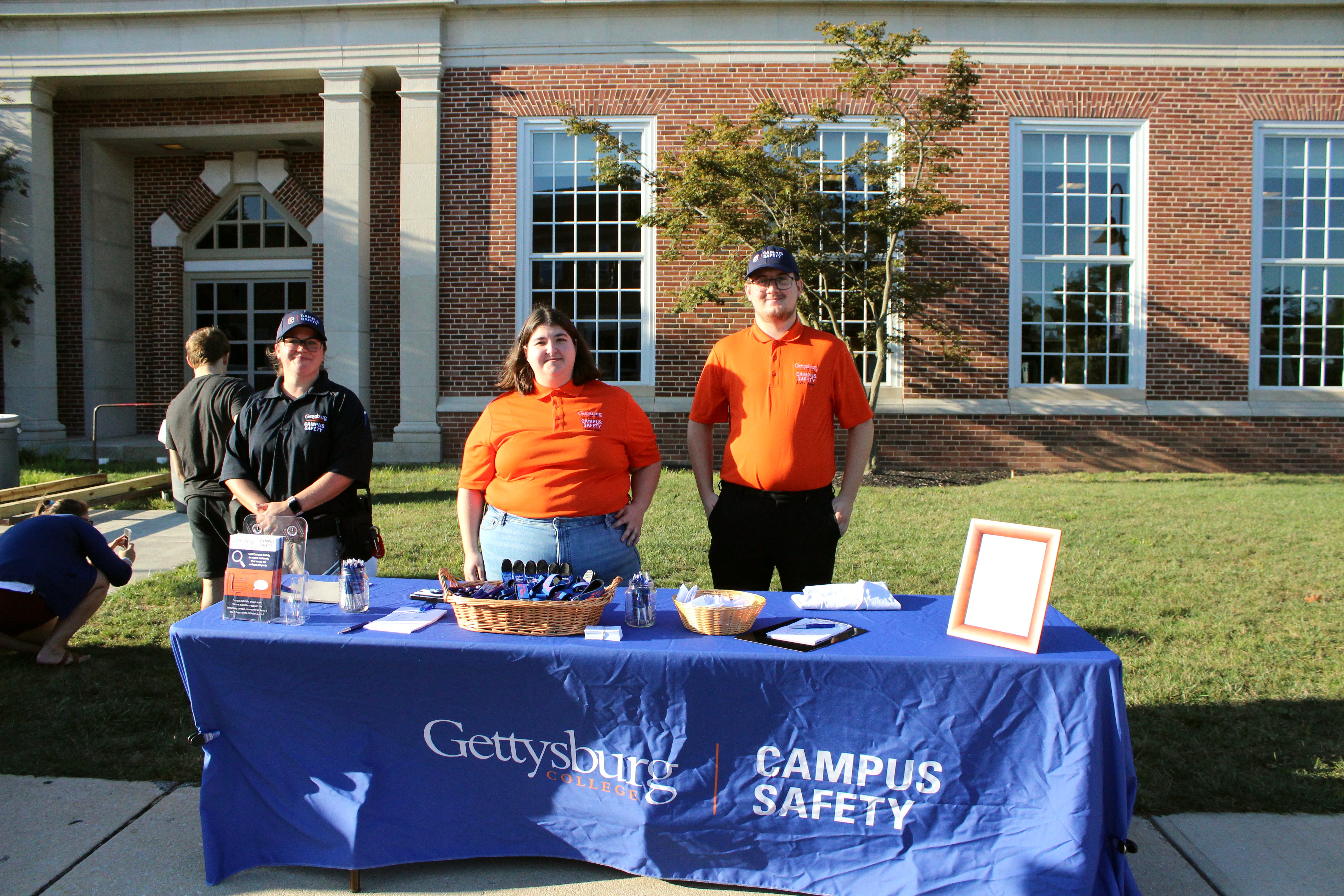 Campus Safety employees work at their table at Campus Safety Day. (Photo Grace Jurchak/The Gettysburgian)