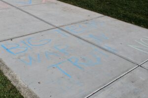 Chalk on the sidewalk outside of CUB: "Big Tech's War on Truth." (Photo Joshua Fackler/The Gettysburgian)