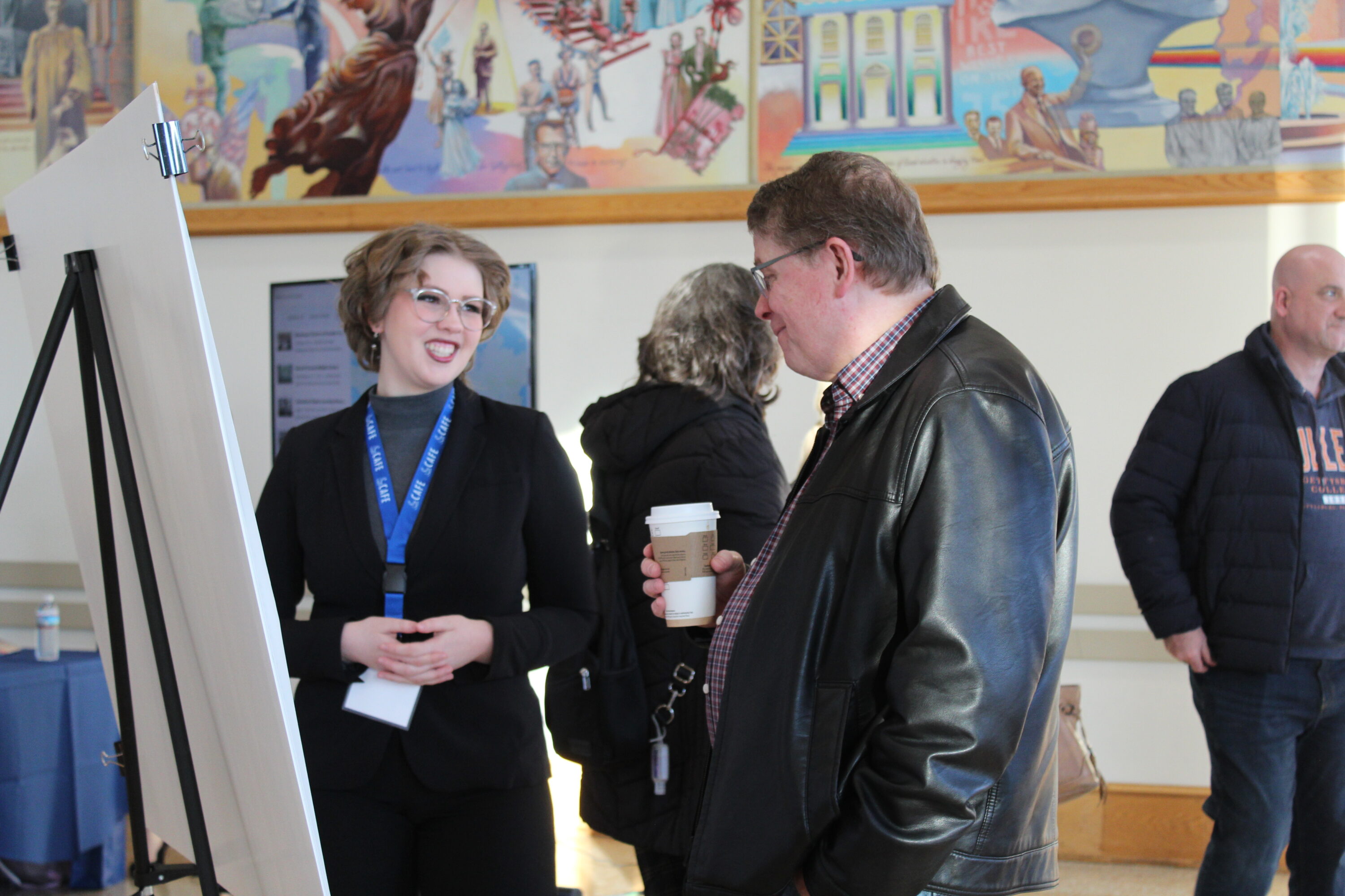 A student discusses their research with an attendee. (Photo Jessica Chernoff/The Gettysburgian)