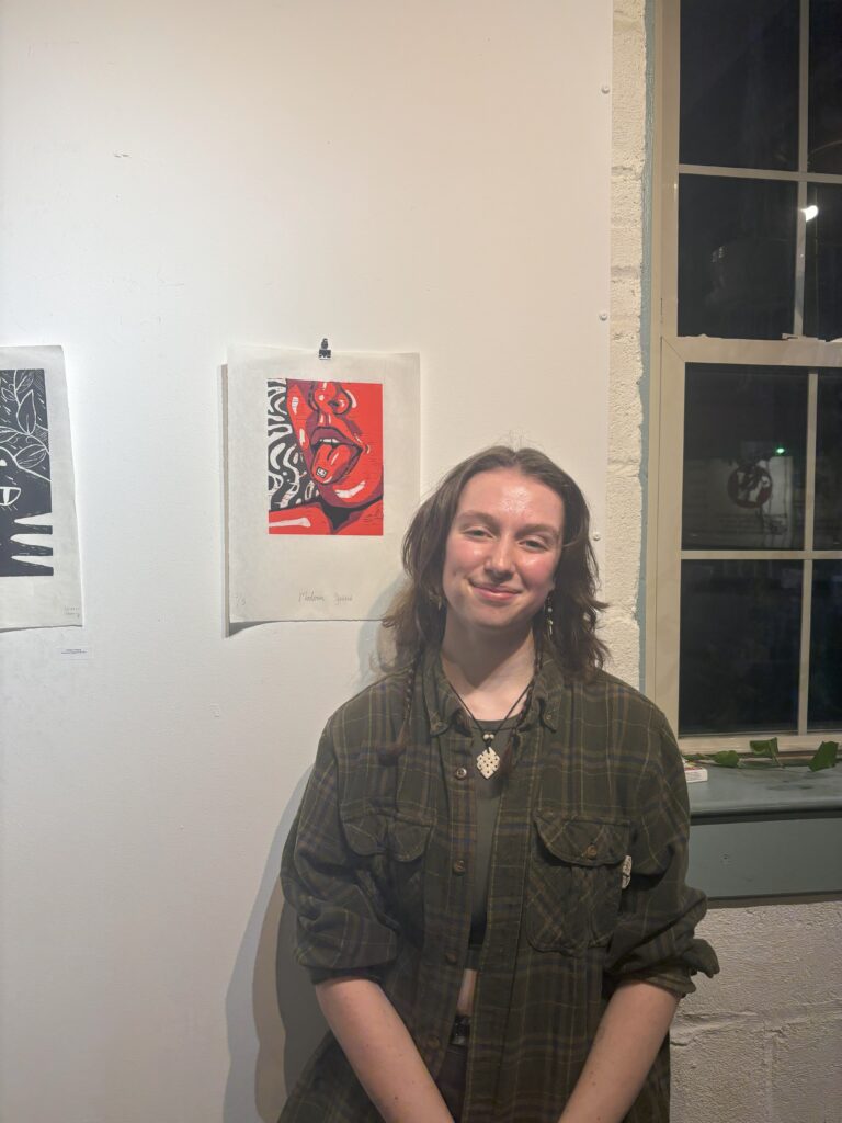 Molly Cordray ’24 with her artwork. (Photo Cassidy Haines/The Gettysburgian)